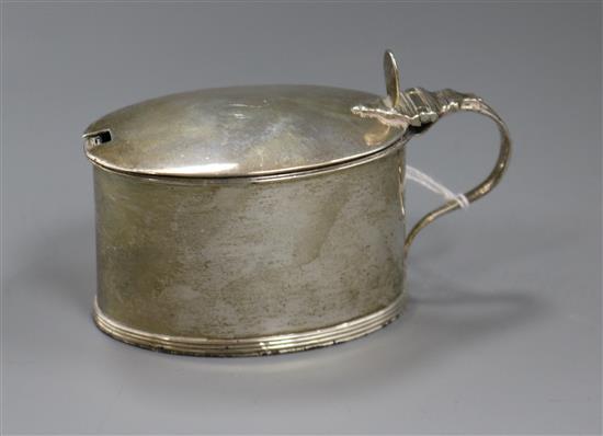 A George III silver oval mustard pot and cover.